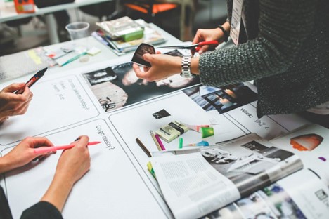 A team creating a marketing collage out of old magazines.